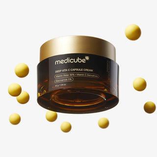 Pot ferme Medicube Deep Vita C Capsule Cream entoure de capsules de vitamine C jaunes