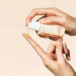 Goutte doree du Seoul 1988 Glow Serum K-Secret versee sur le bout du doigt depuis la pompe