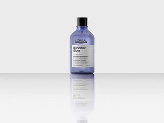 Flacon violet L'OREAL PROFESSIONNEL Blondifier Gloss 300ml sur surface reflechissante fond gris