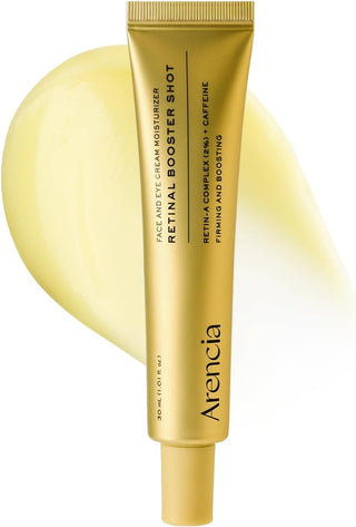 Tube doré ARENCIA Retinal Booster Shot 30ml sur swatch de crème jaune pâle - Retin-A Complex 2% et caféine