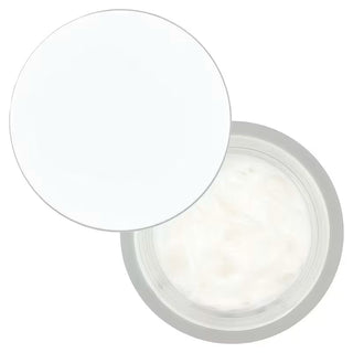 Pot Dynasty Cream ouvert vu du dessus, couvercle posé à côté et texture crème blanche