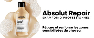 Flacon dore L'Oreal Professionnel Absolut Repair Shampoing avec texte Repare et renforce sur fond blanc