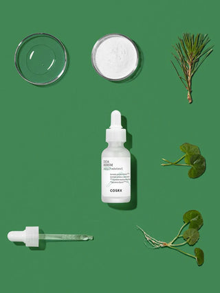 Flatlay COSRX Pure Fit Cica Serum avec pipette, centella asiatica, poudre blanche et boite de petri sur fond vert