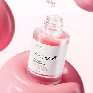 Medicube PDRN Pink Peptide Serum flacon ouvert avec pipette et bulles de gel rose en suspension