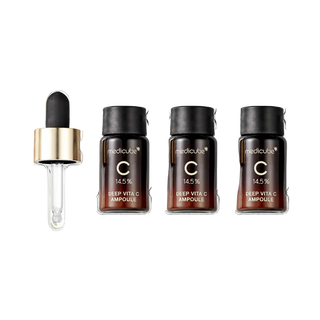 Trois flacons Medicube Deep Vita C Ampoule 2.0 avec pipette et recharges vus de dessus sur fond blanc