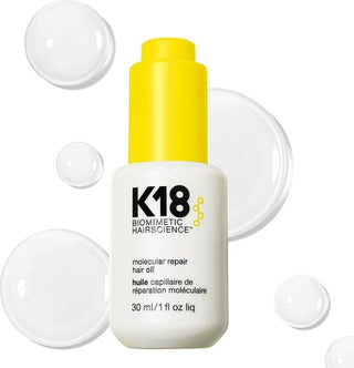 K18 Molecular Repair Hair Oil 30 ml - flacon blanc bouchon jaune entoure de bulles transparentes sur fond blanc