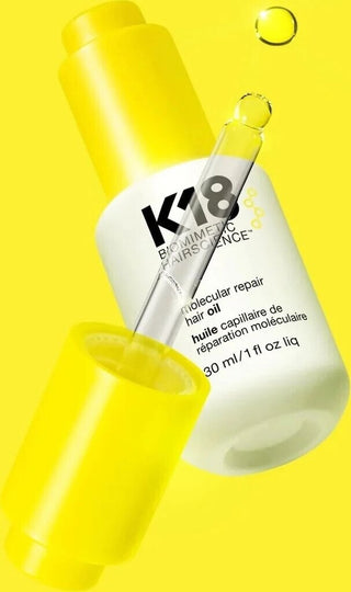 K18 Molecular Repair Hair Oil - flacon ouvert avec pipette doree et goutte sur fond jaune vif