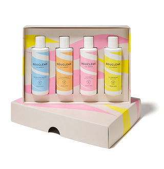 Boucleme Starter Kit - quatre flacons colores ranges dans leur coffret carton rose et jaune ouvert